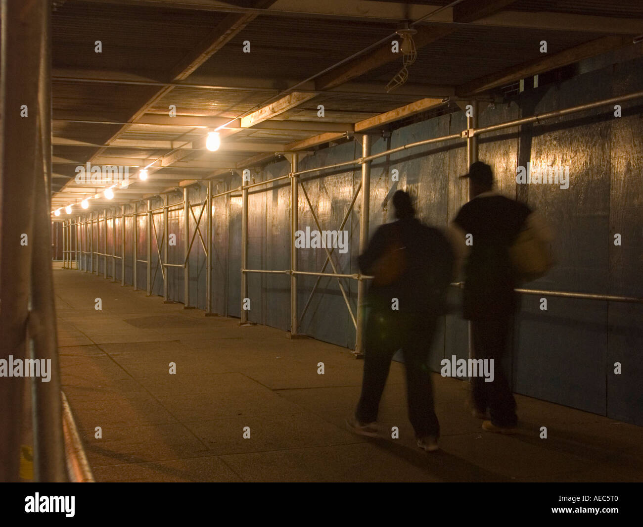People walk under scaffolding Stock Photo - Alamy