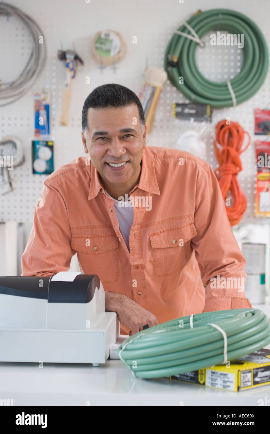 African hardware store owner smiling behind counter Stock Photo Alamy