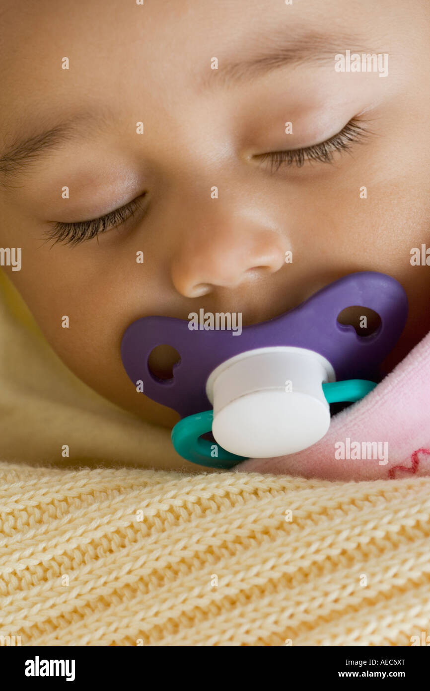 Close up of Hispanic baby sleeping with pacifier Stock Photo Alamy