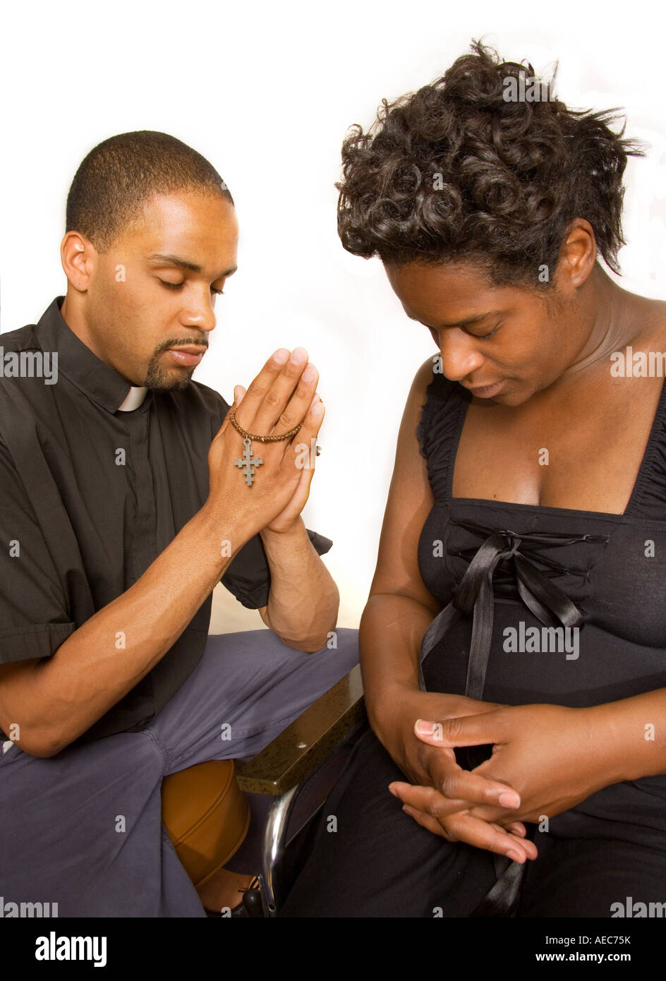 Religious man prayers with woman. Stock Photo