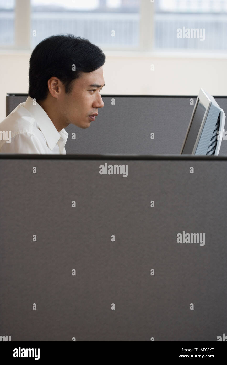 Asian businessman working in cubicle Stock Photo - Alamy