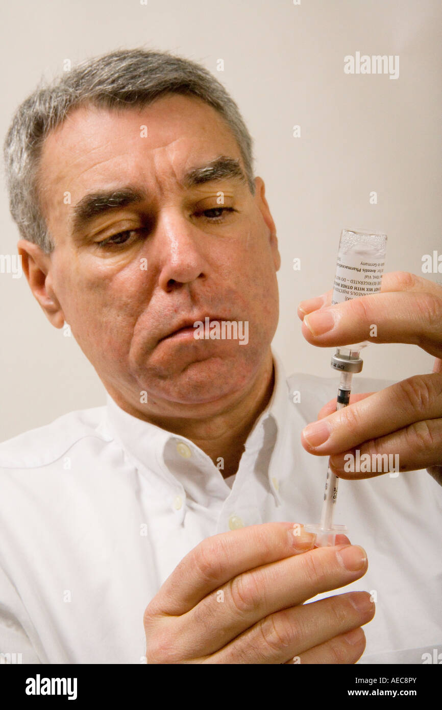 Patient measures insulin for self injection Stock Photo Alamy