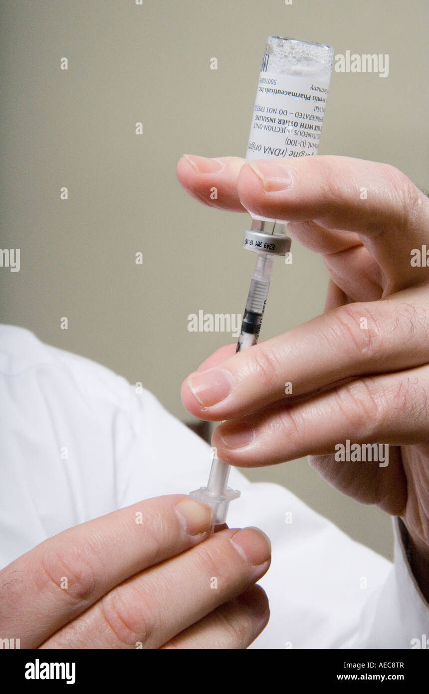 Diabetic fills syringe with insulin Stock Photo Alamy