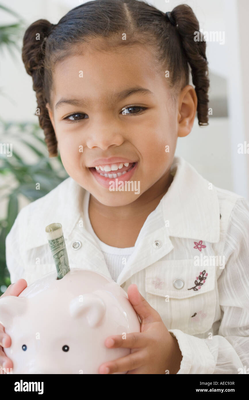 African girl holding piggy bank Stock Photo - Alamy