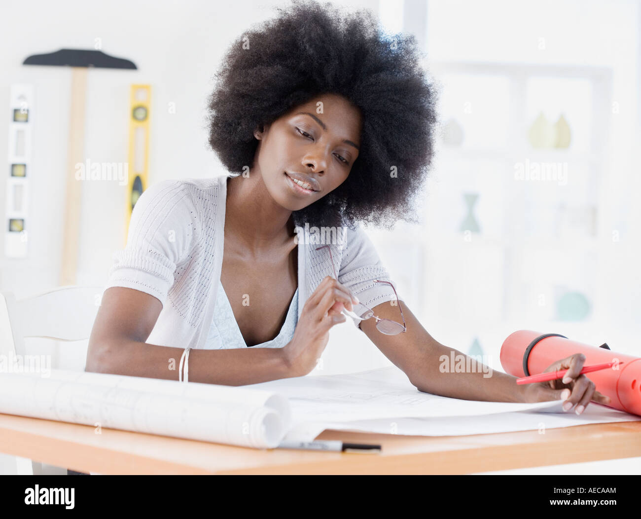 African female architect looking over blueprints Stock Photo - Alamy