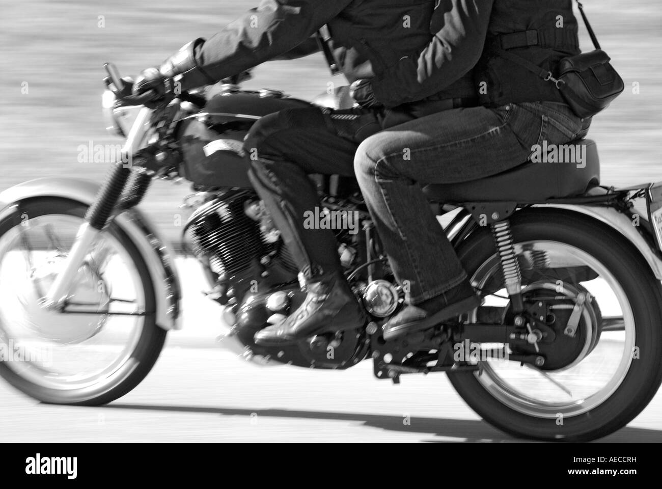 'Couple riding a modified and updated ^1950s Vincent Rapide ^998cc 'V twin' motorcycle. (Speed blur.)' Stock Photo