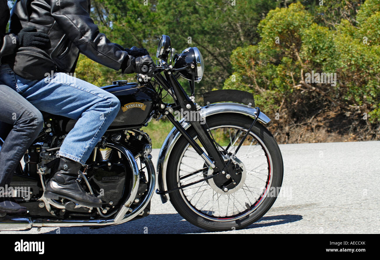 'Couple riding a restored classic ^1950s Vincent Black Shadow ^998cc V twin motorcycle. (Speed blur.)' Stock Photo