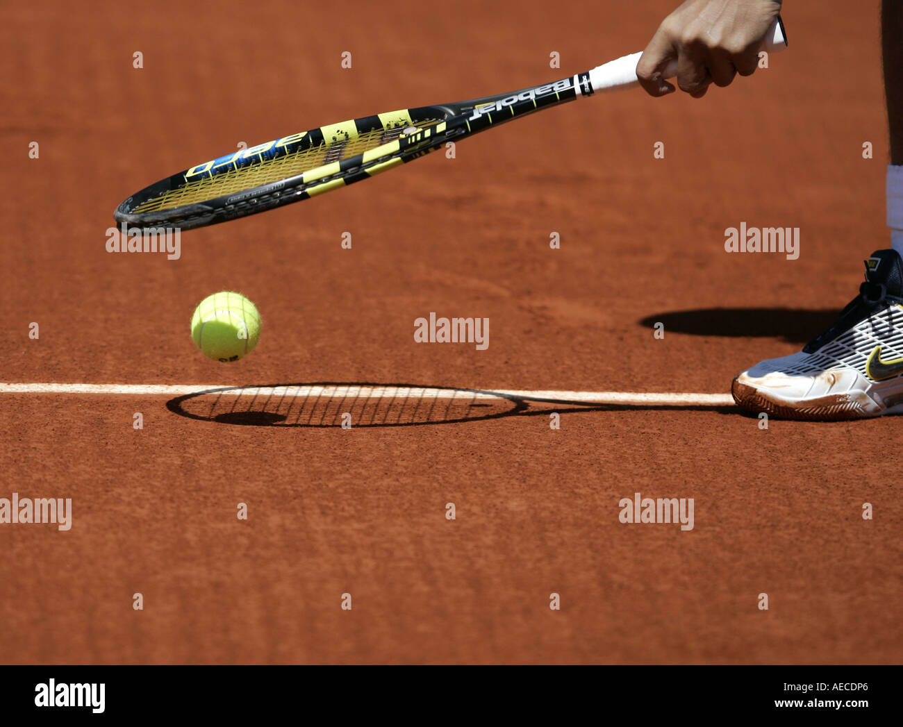 Racket tapping  ball on the baseline at the French Open Stock Photo
