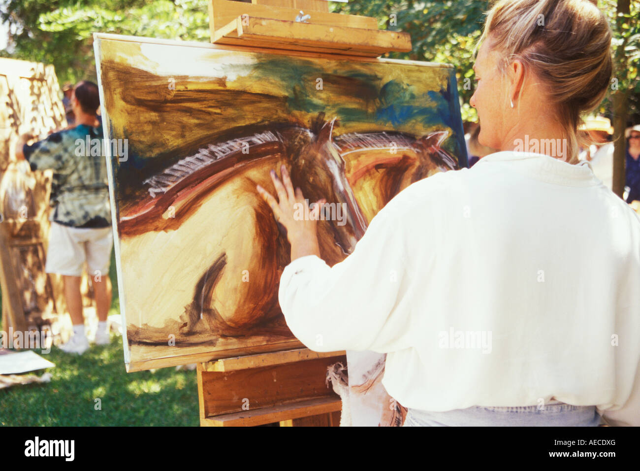 woman painting horses Los Olivos Quick Draw and Auction Los Olivos Santa Ynez Valley California Stock Photo