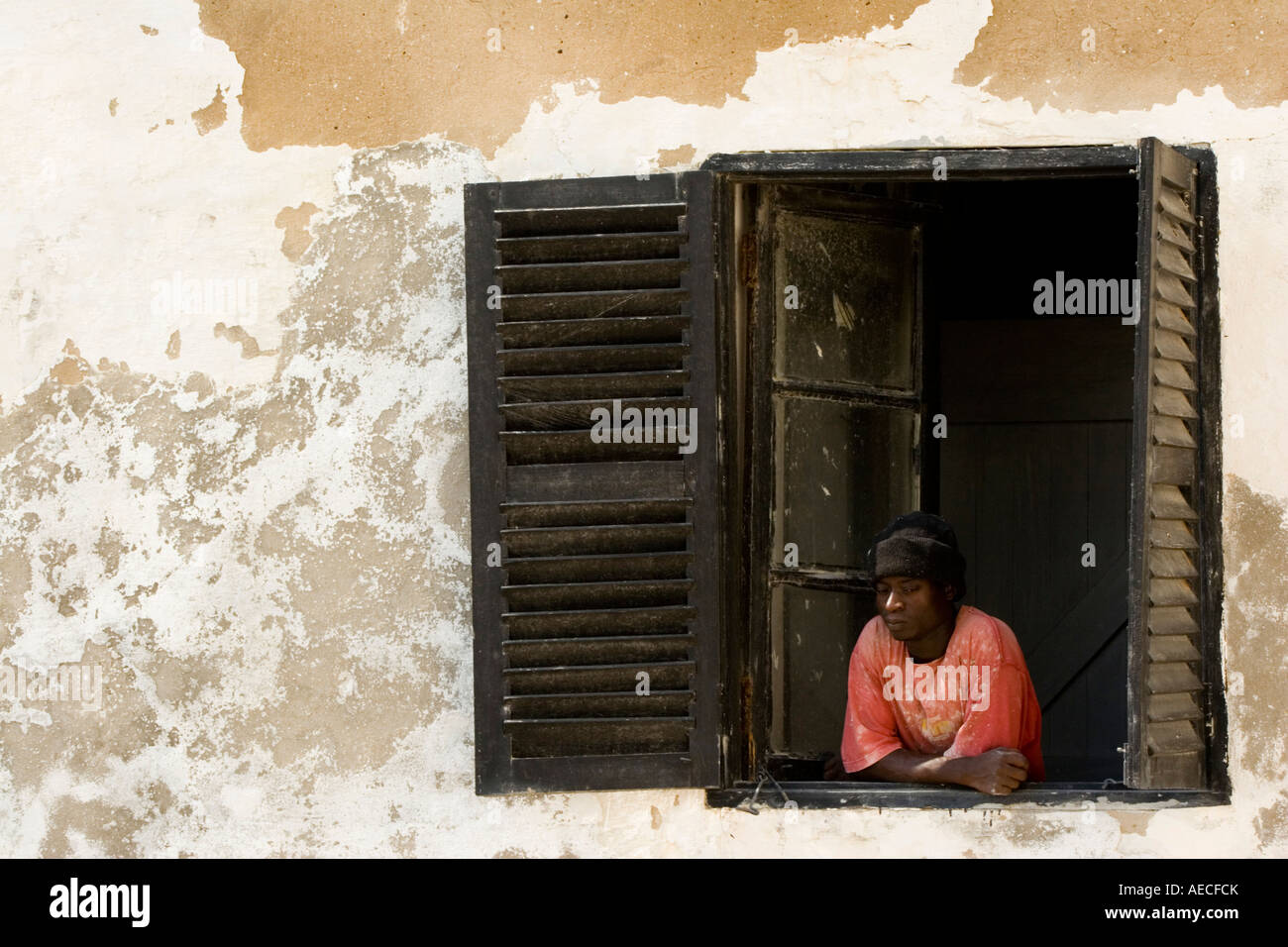 African man looking out from window Ghana Africa Stock Photo
