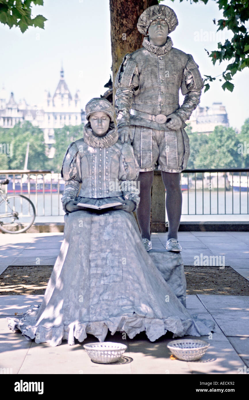 A couple in period costumes busking on the south bank of the Thames river in London. Stock Photo