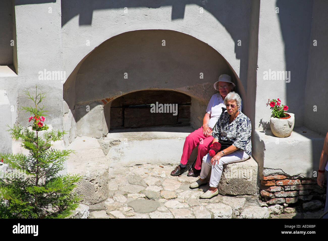 Tourists relaxing in the courtyard, Bran Castle, Bran, near Brasov, Transylvania, Romania Stock Photo