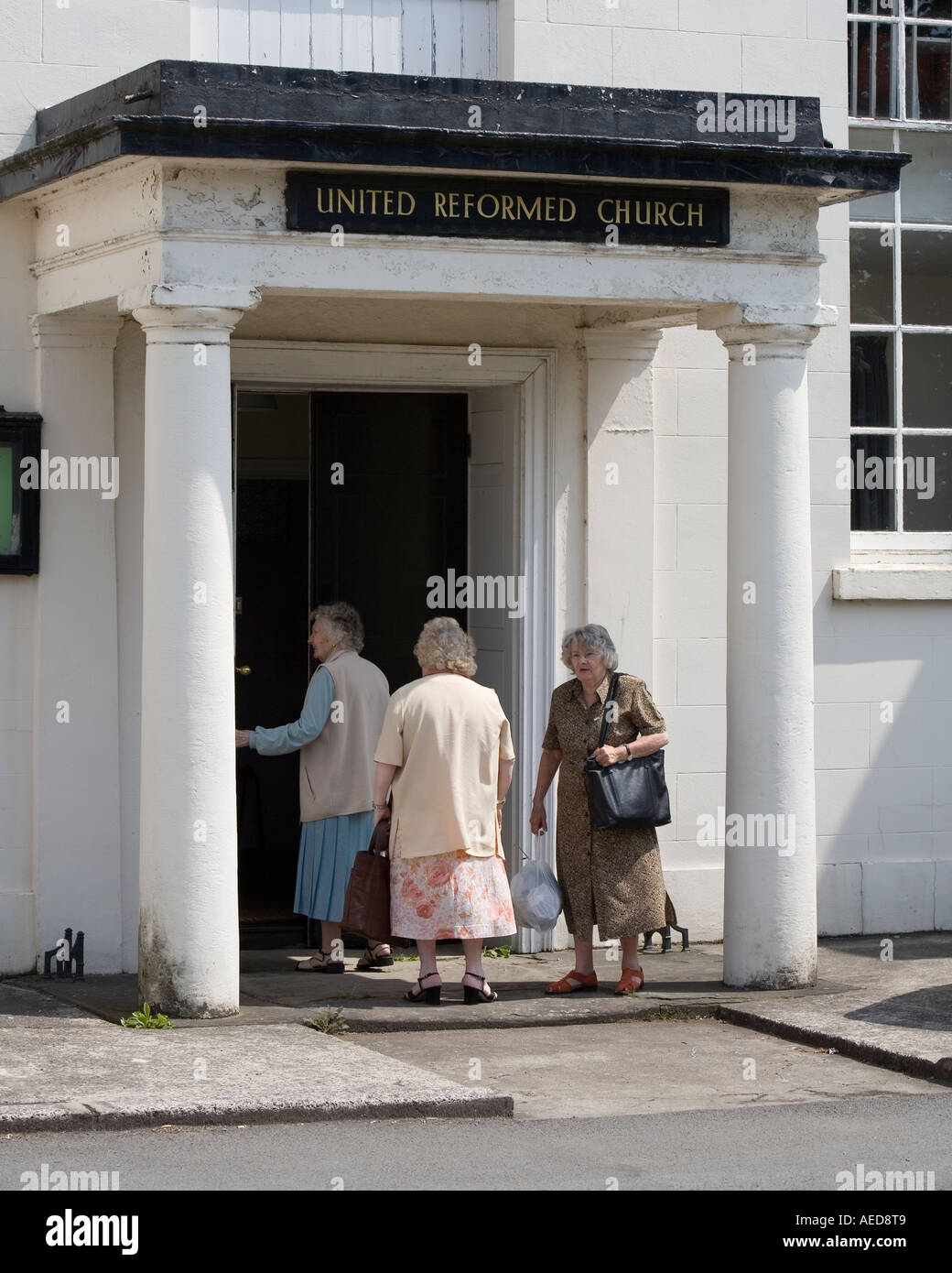 Three ladies entering the United Reformed Church Abergavenny Wales UK Stock Photo
