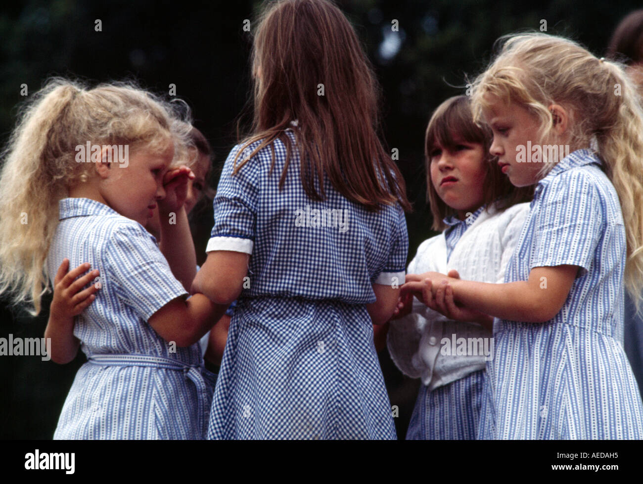 School Girls In Playground Reconciling After Argument England Stock Photo