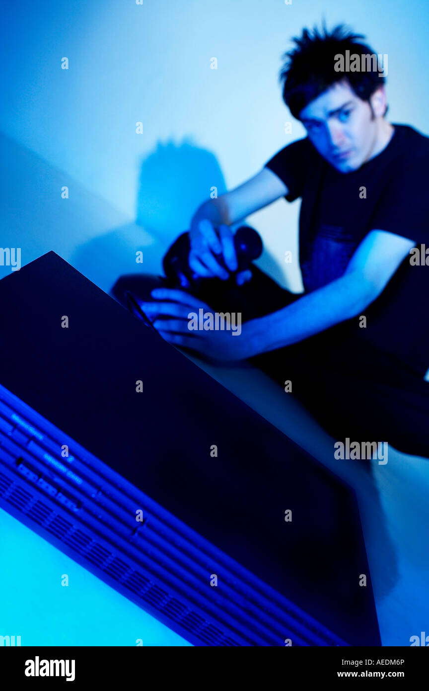 Young Man playing with a computer console Stock Photo - Alamy
