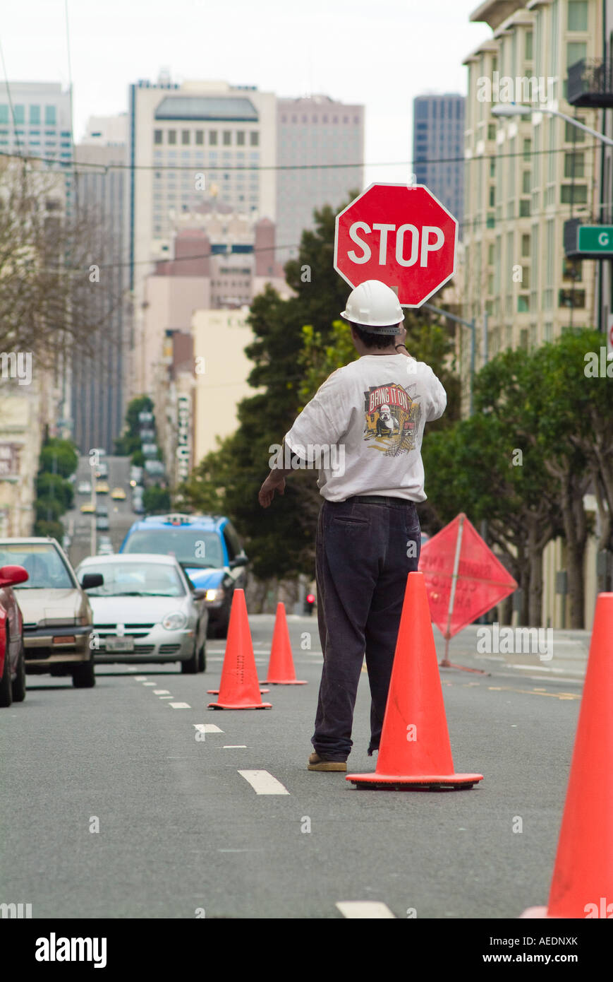 Construction worker holding stop sign on city street Stock Photo - Alamy