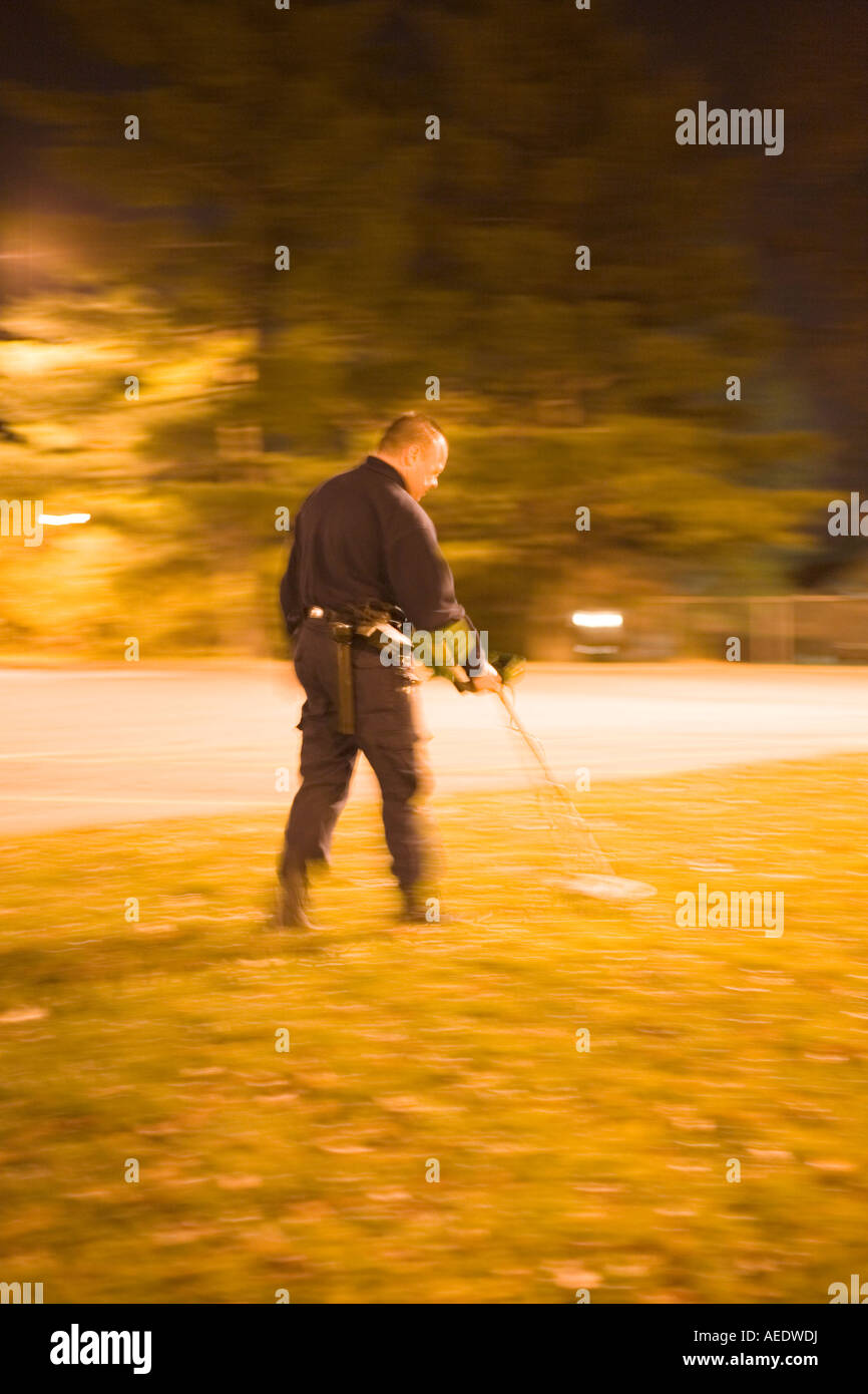 CSI using metal detector to search for bullets nd casings. Kansas City