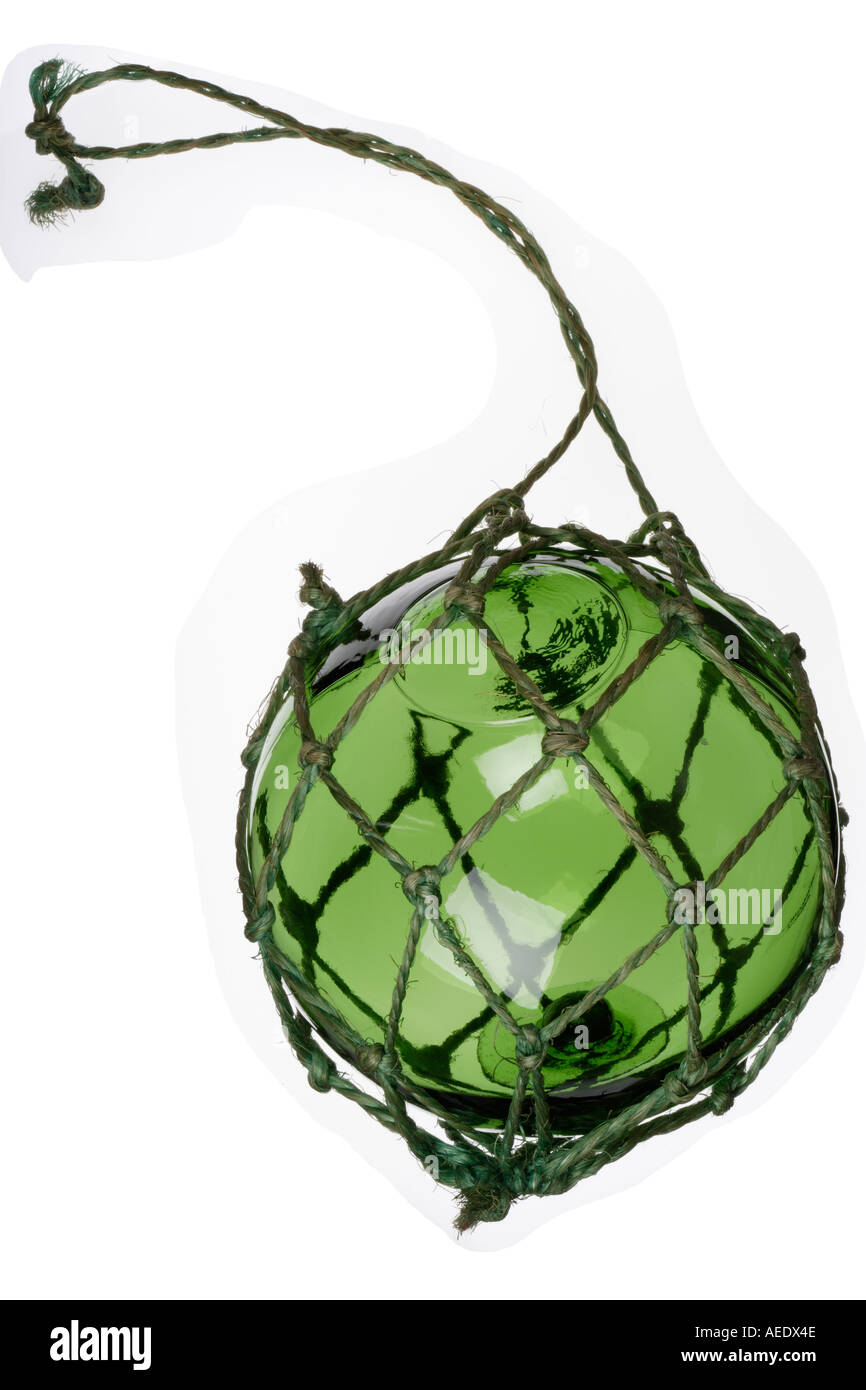 Green glass fishing net float in green string net Stock Photo - Alamy
