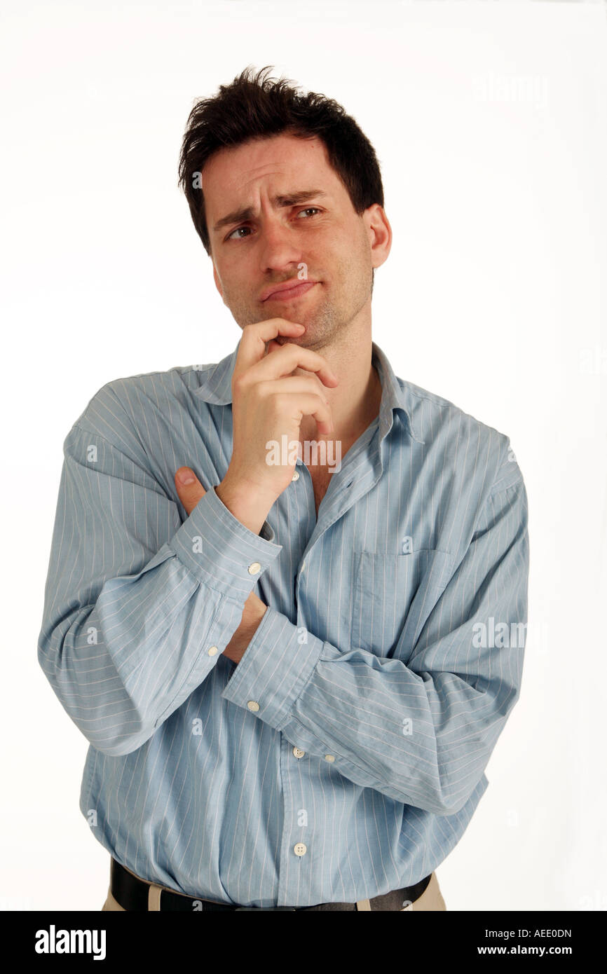 Young man looking confused, against a white background Stock Photo - Alamy