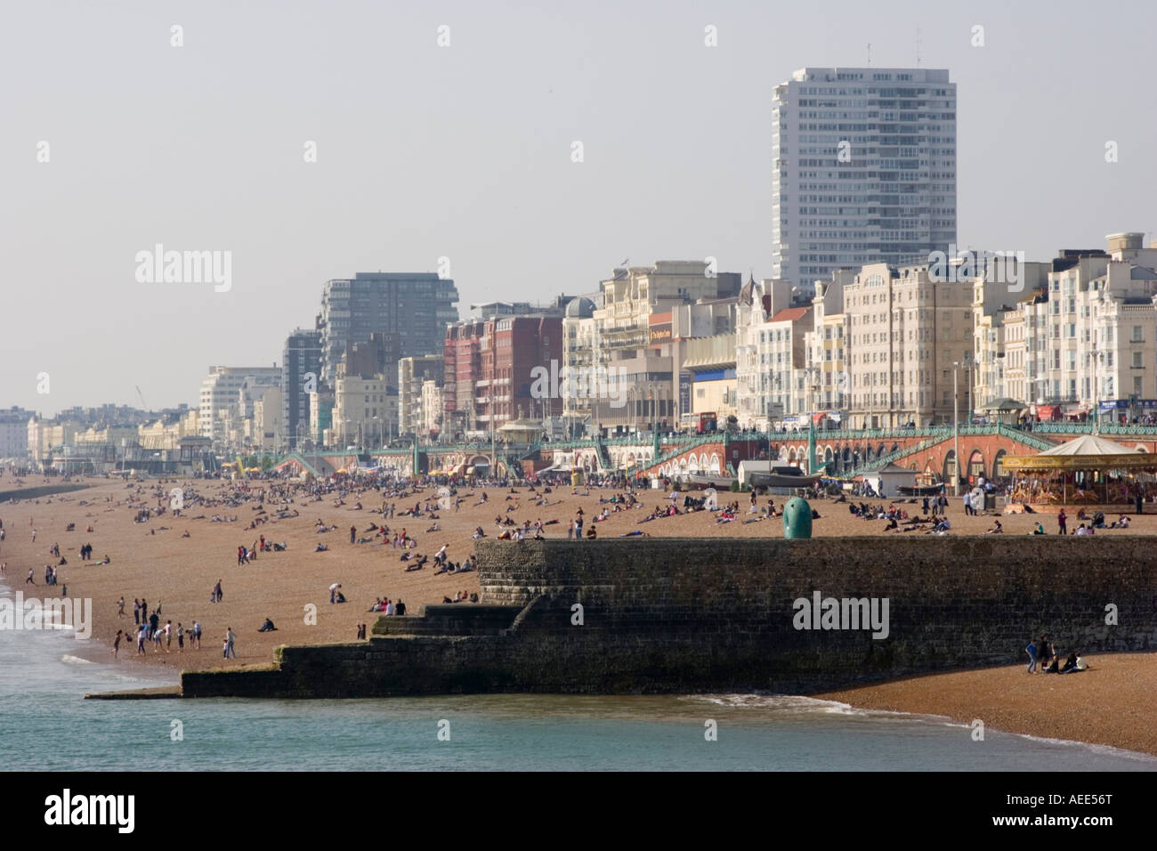A busy and crowded Brighton beach and sea front on an unseasonably warm day in April Stock Photo