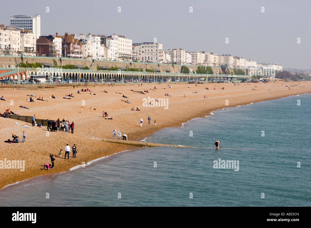 A busy and crowded Brighton beach and sea front on an unseasonably warm day in April Stock Photo