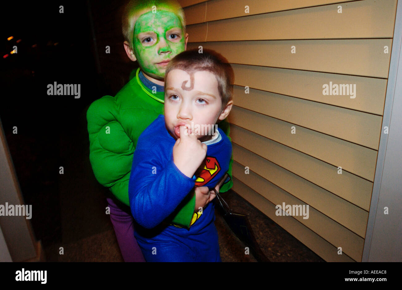 Boys dressed up like the incredible hulk and superman Stock Photo
