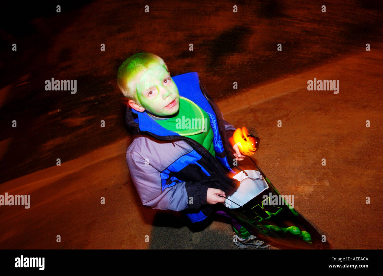 Boy in costume walking with trick or treat bag on Halloween Stock Photo