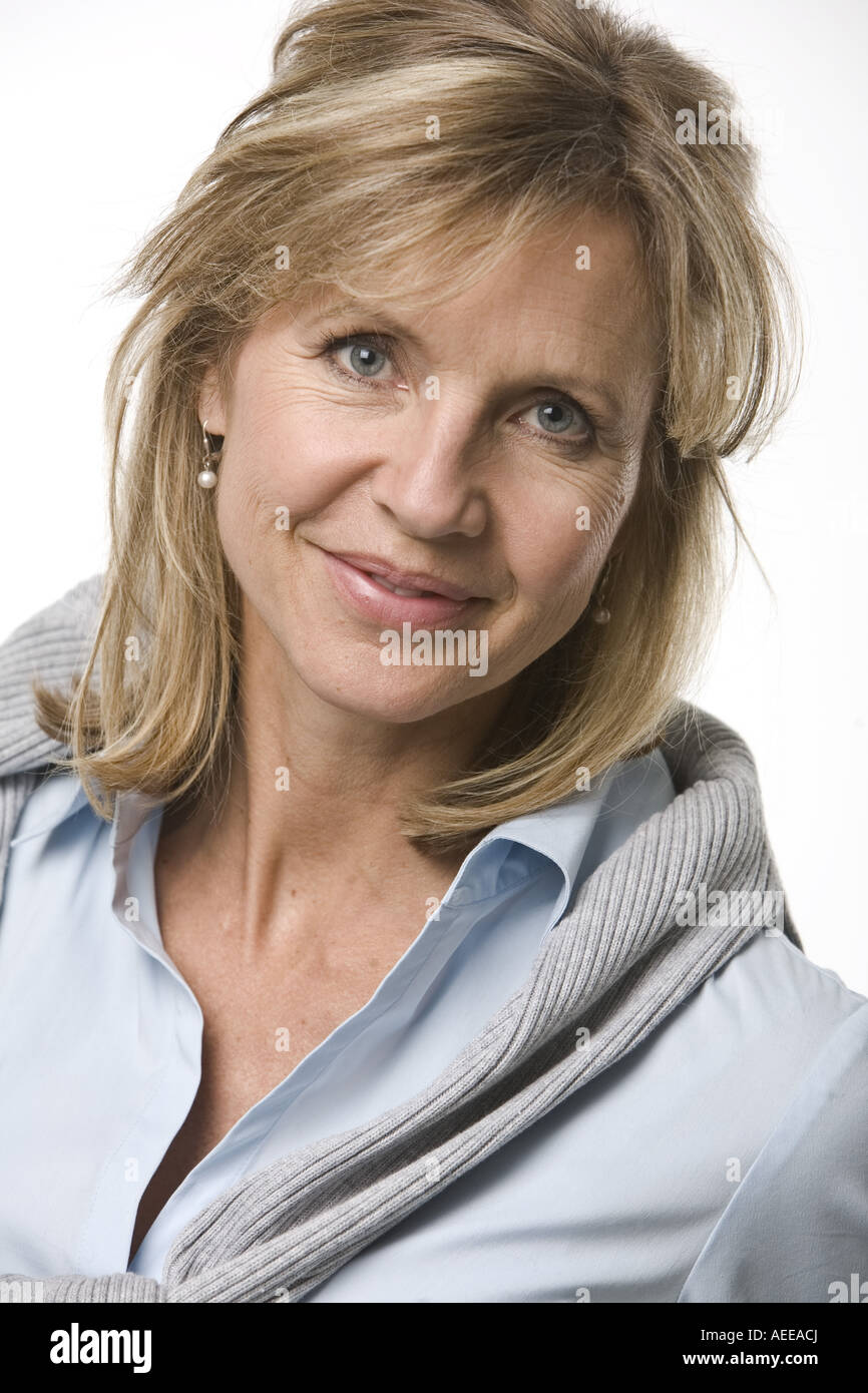 A woman poses for photographs in a studio Stock Photo - Alamy