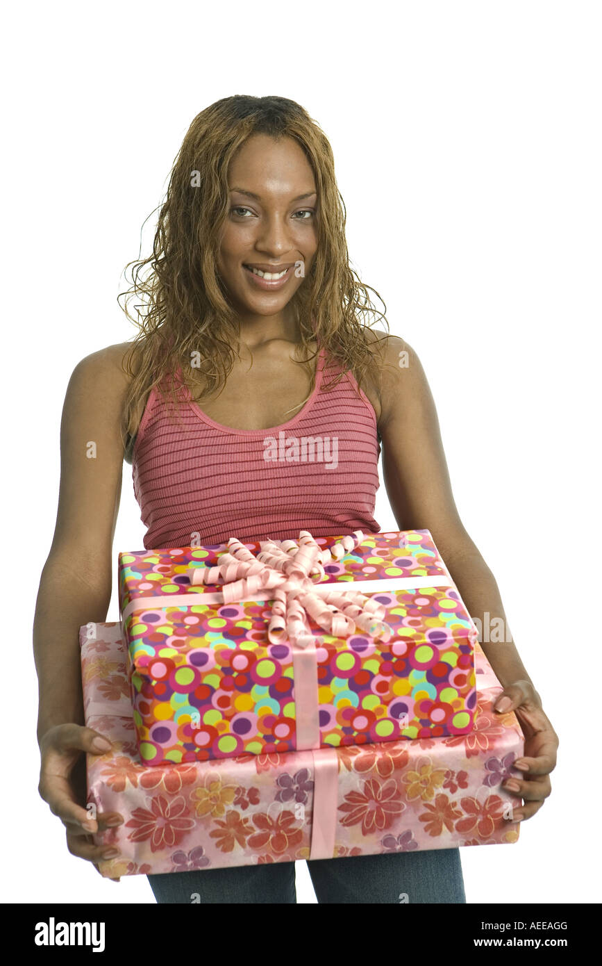 A young woman holding presents in a studio Stock Photo - Alamy
