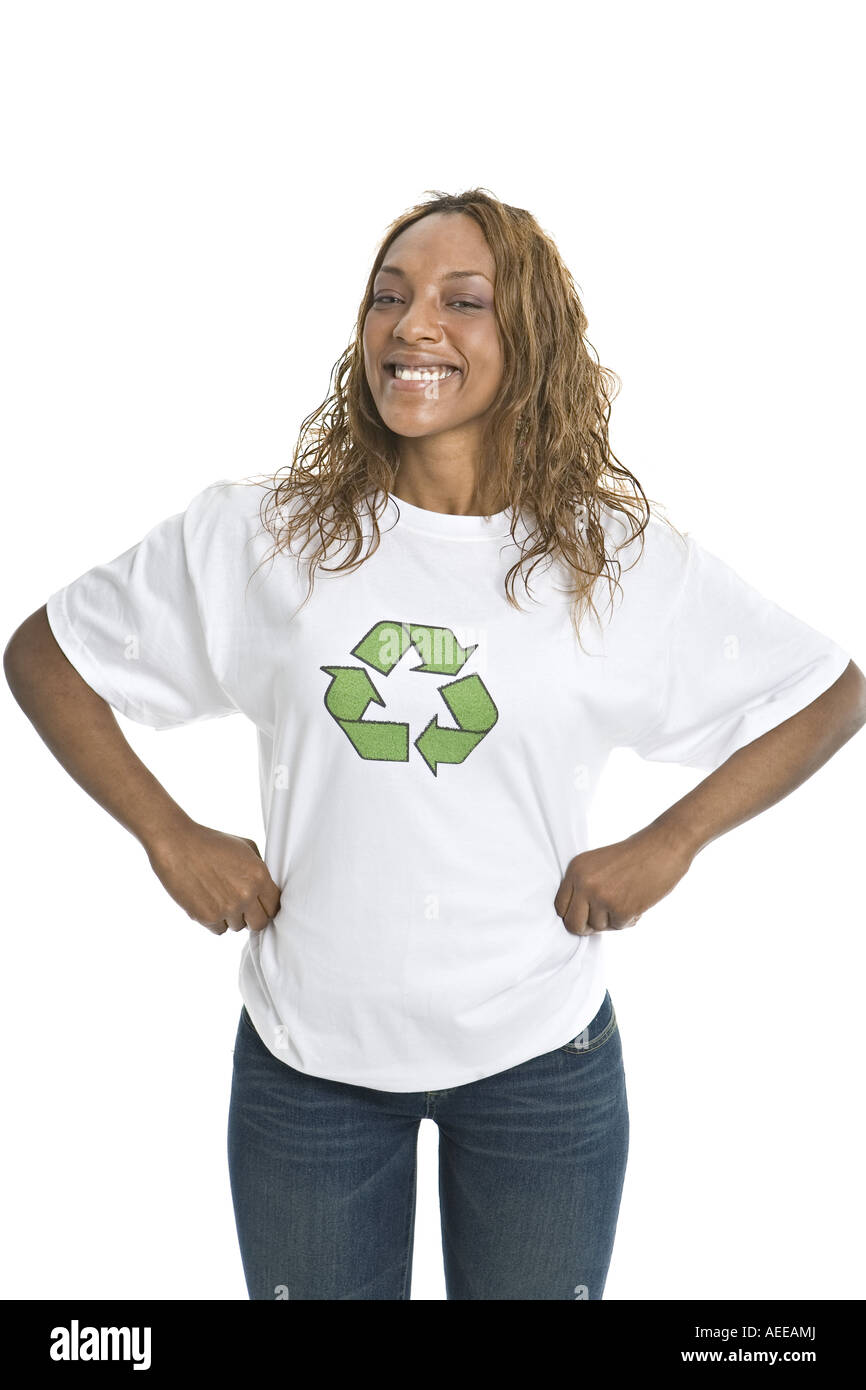 A young woman poses for photographs in a studio wearing a t-shirt promoting recycling. Stock Photo