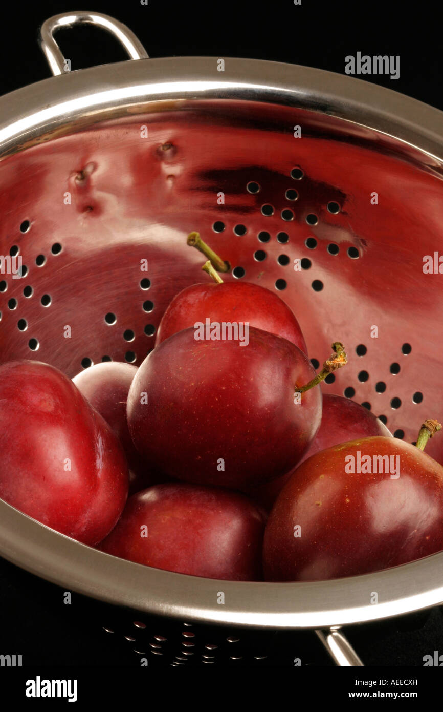 Fresh Plums in a stainless steel colander Stock Photo