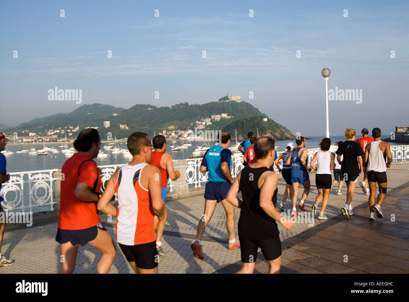 Large group of joggers running in the morning along the Playa de La Concha, San Sebastian, Spain Stock Photo