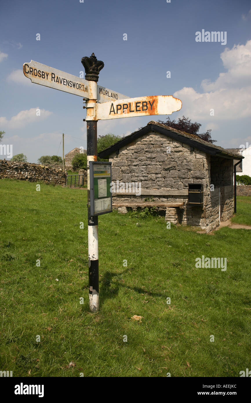 Road sign and bus stop in Cumbria Crosby Ravensworth Appleby Norland Stock Photo