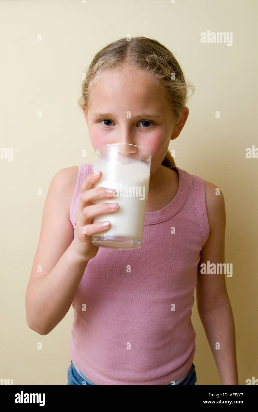 Girl drinking glass of milk England UK Stock Photo