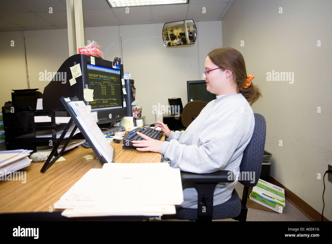 Female inmate working with data entry in the Nebraska Correctional Center for Women in York Nebraska USA Stock Photo
