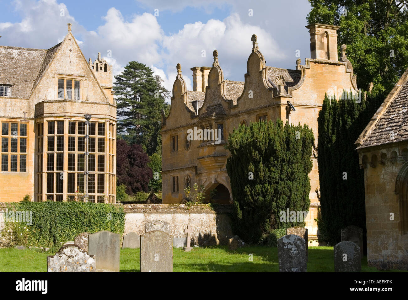 The Jacobean manor and gatehouse of Stanway House seen from the churchyard in the Cotswold village of Stanway, Gloucestershire Stock Photo