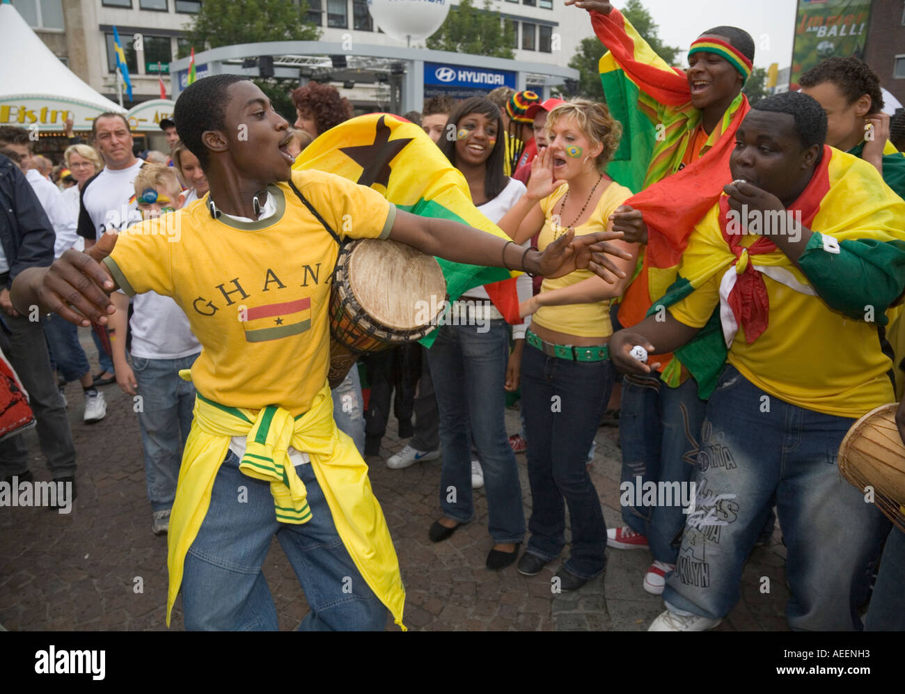 Black and white Ghanaian football fans making music at a public viewing event before the world cup match Brazil vs. Ghana Stock Photo