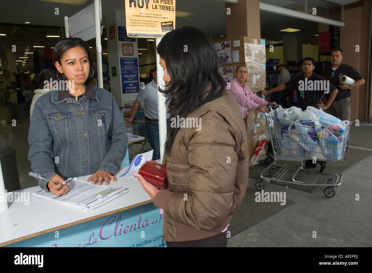 Customers here fill out forms to apply for a WalMart credit card in Mexico City Stock Photo