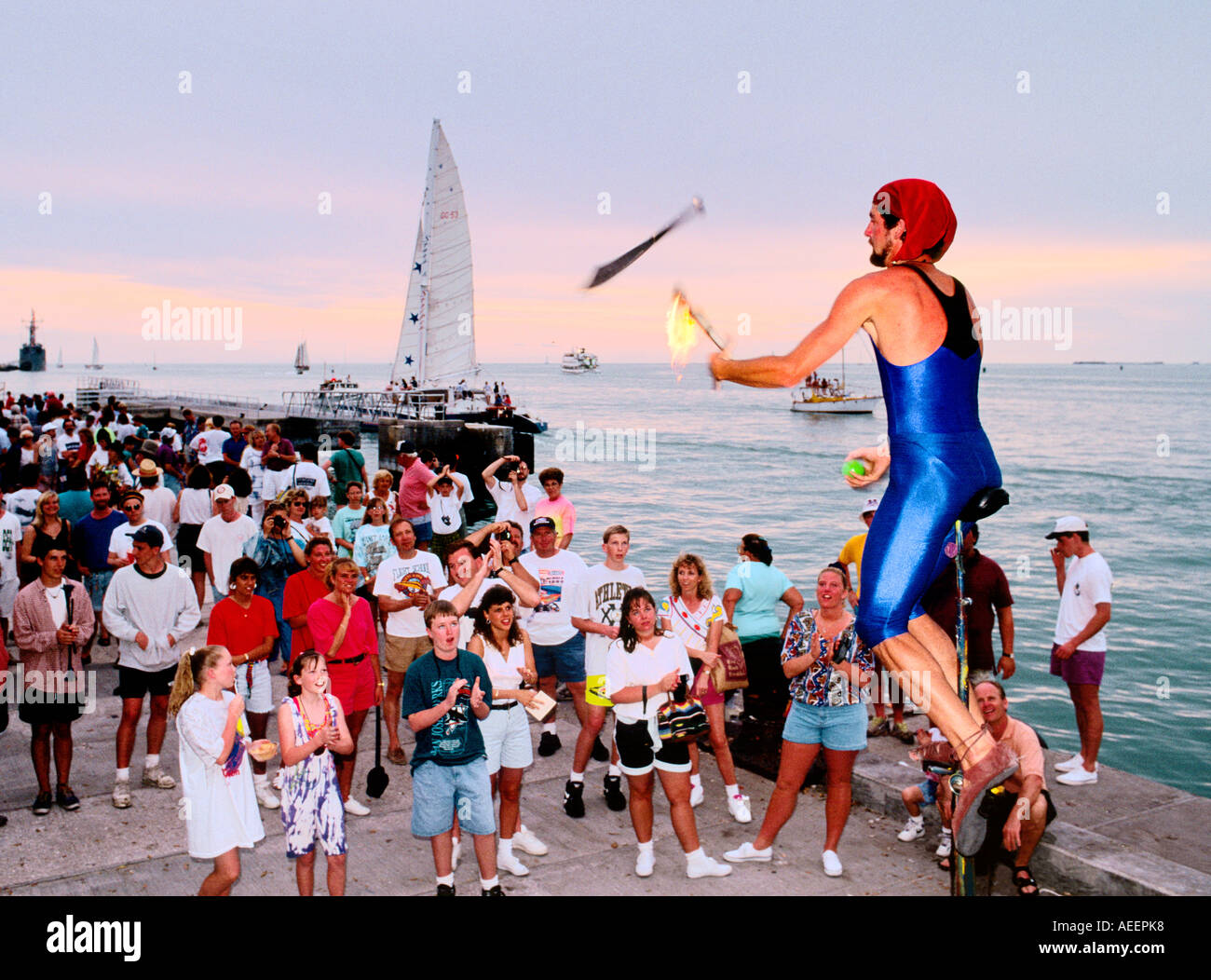 Key West in the Florida Keys, USA. Street entertainer juggler with tourist audience at the harbour Stock Photo