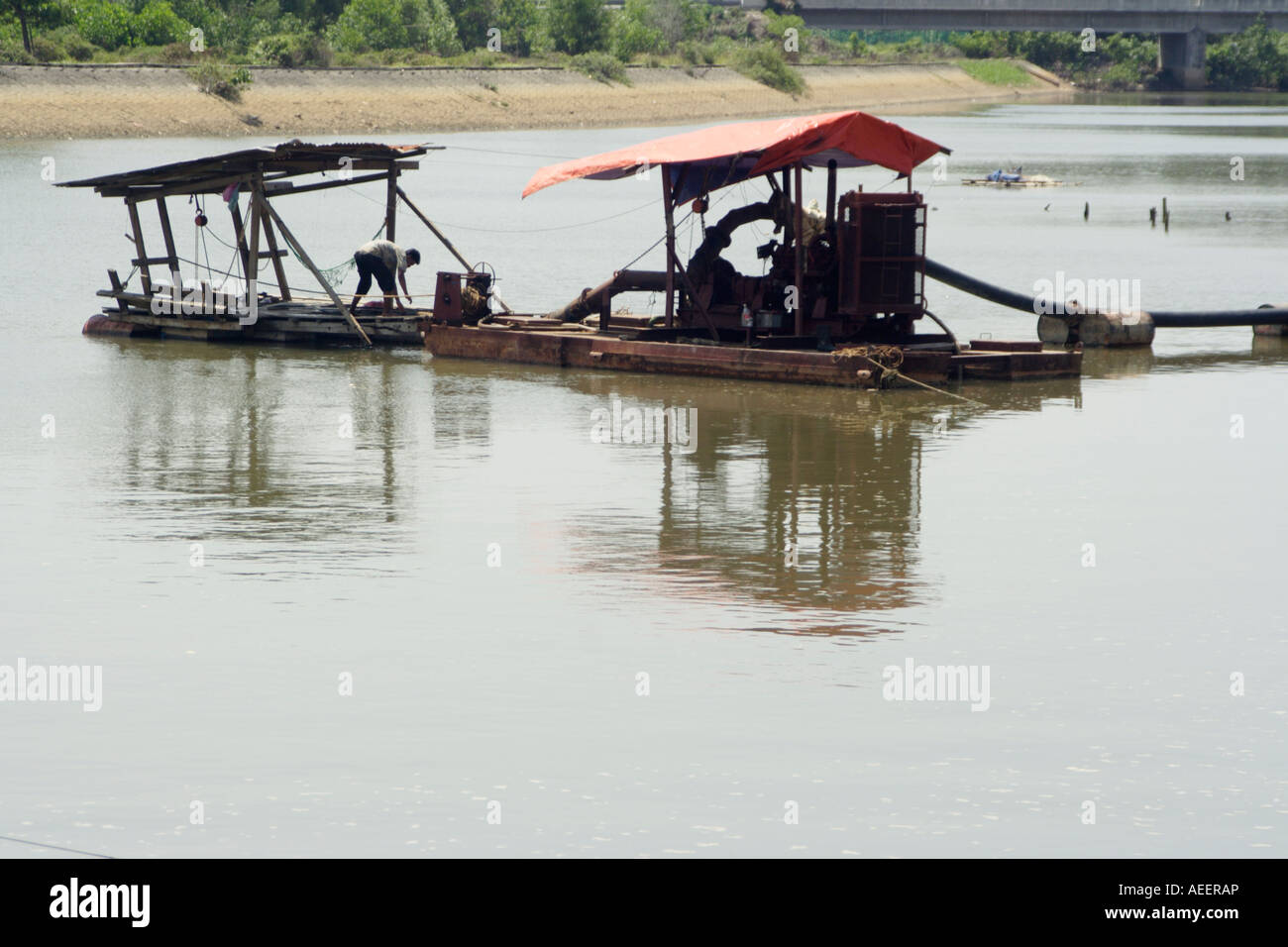 Houseboat for deepening riverbed by sucking out sand and pouring it on the 'river bank'. Stock Photo