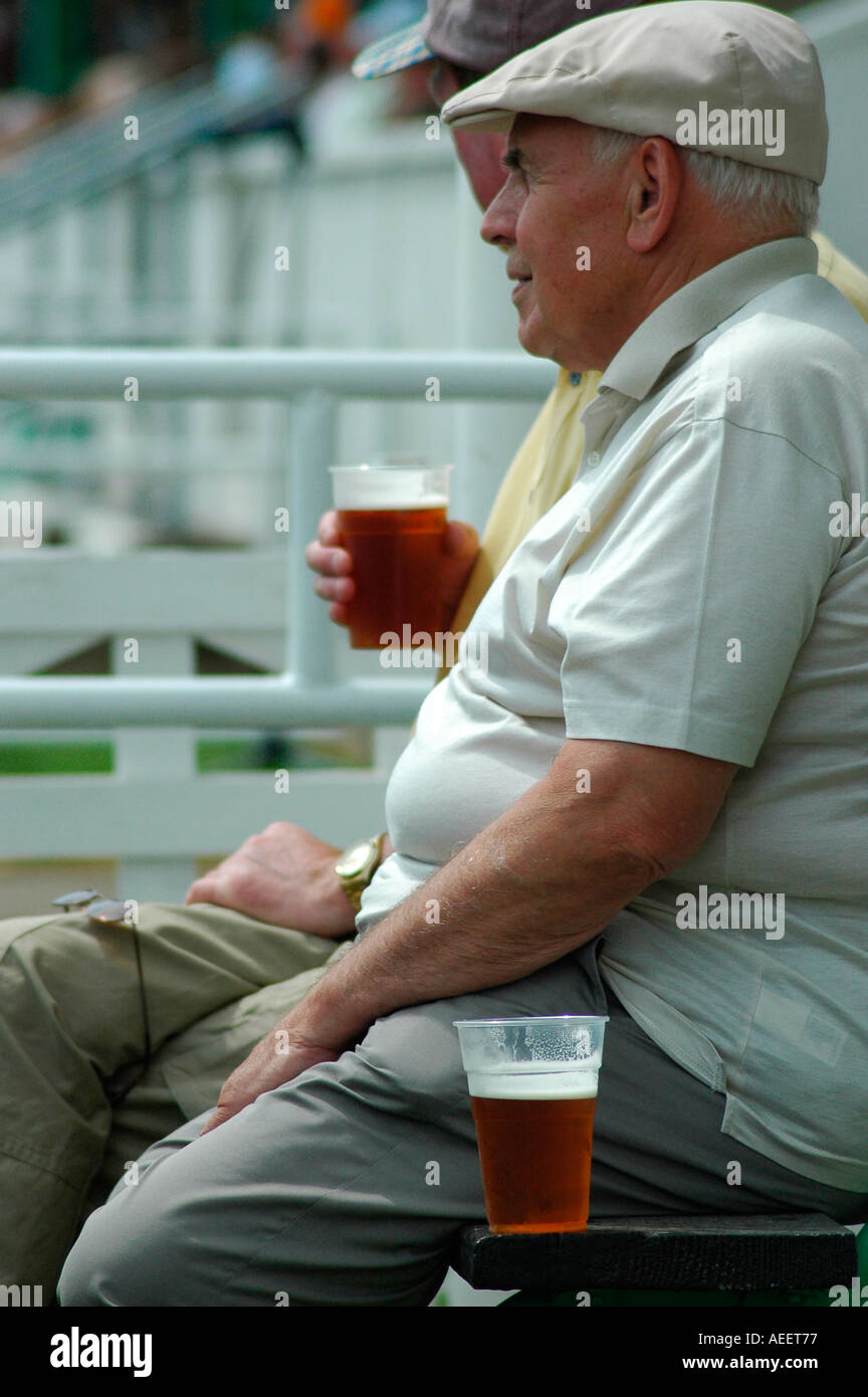 Two middle aged men drinking beer outside Stock Photo Alamy