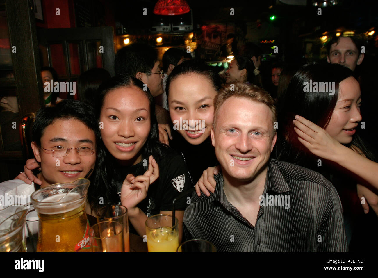 Ex patriot European having a good time with local friends in one of the bars along the lively Maoming Road Shanghai Stock Photo