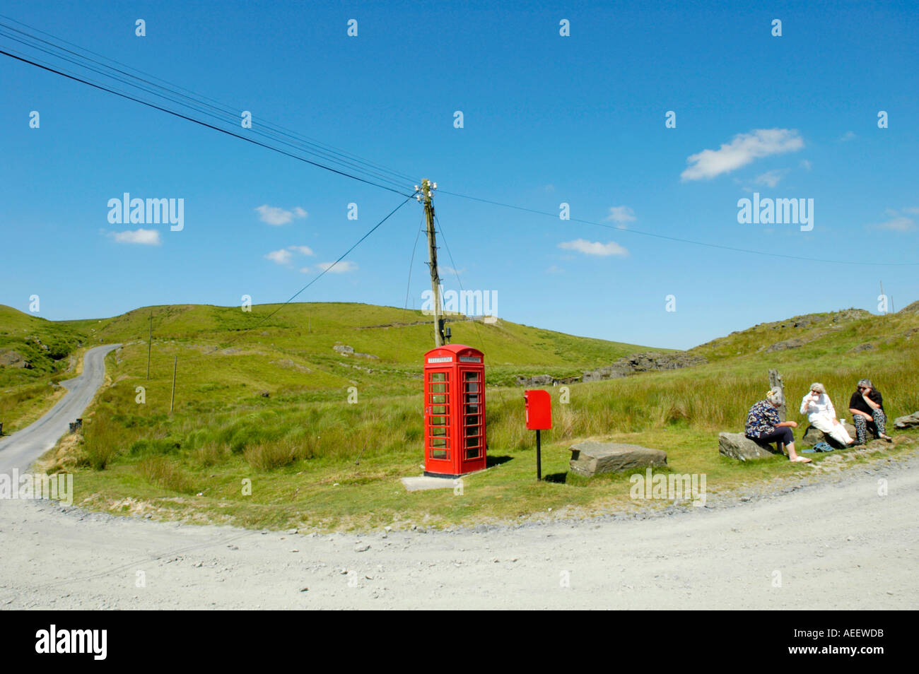 Little used red BT phonebox  and mailbox 8 miles from the nearest town in open countryside Mid Wales UK Stock Photo