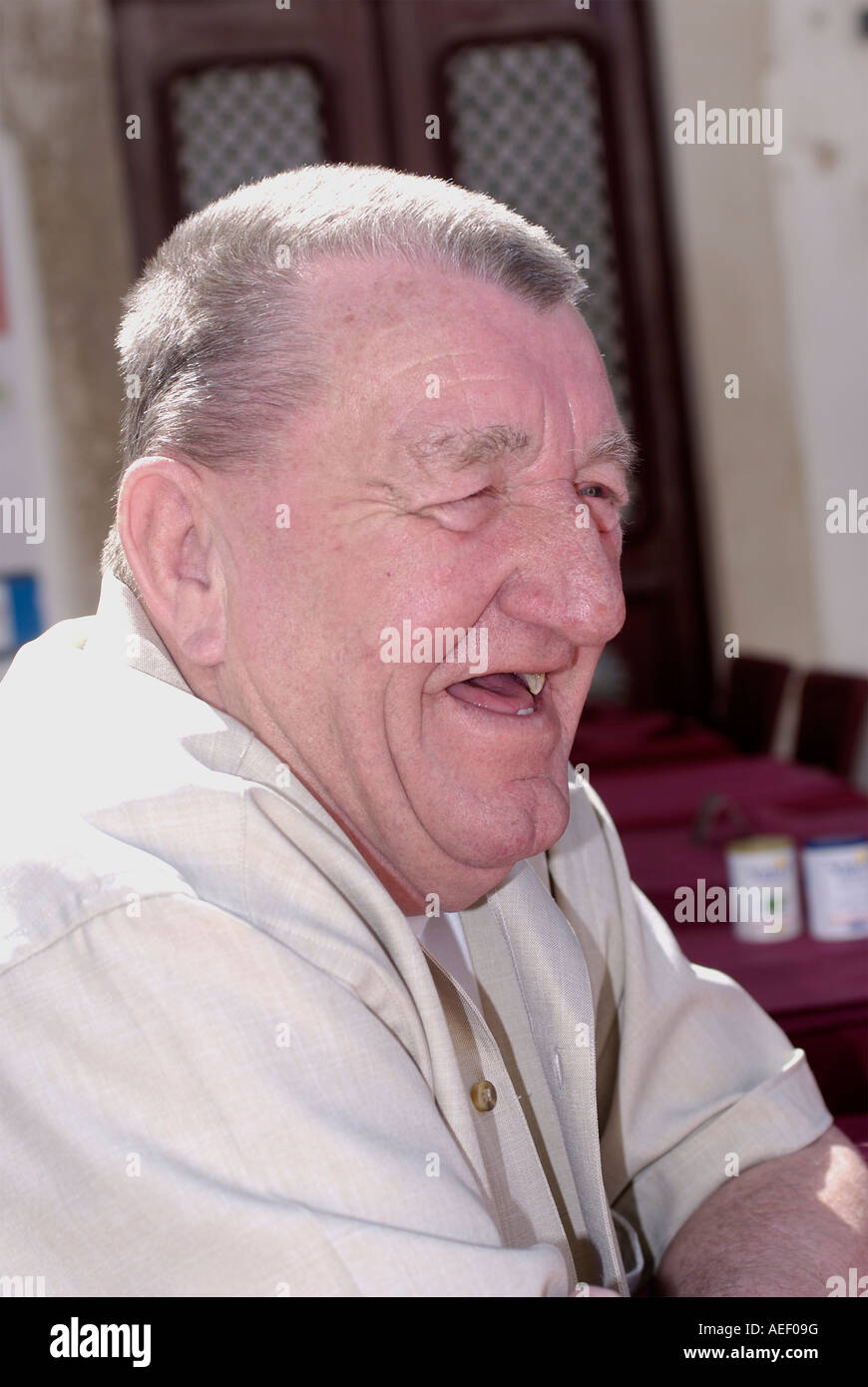 An old red faced toothless man laughing Stock Photo