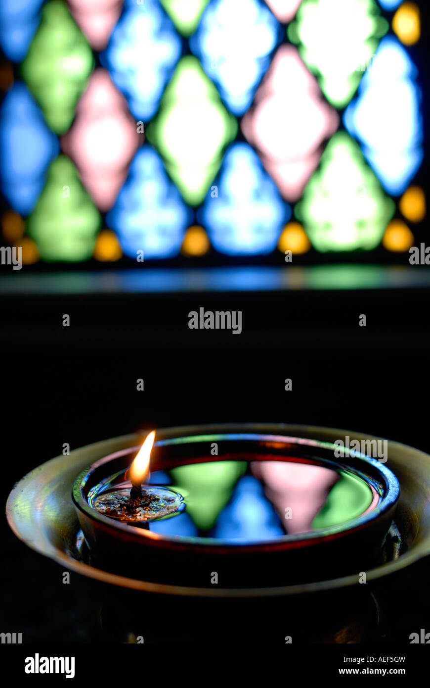 Lit church candle Stock Photo