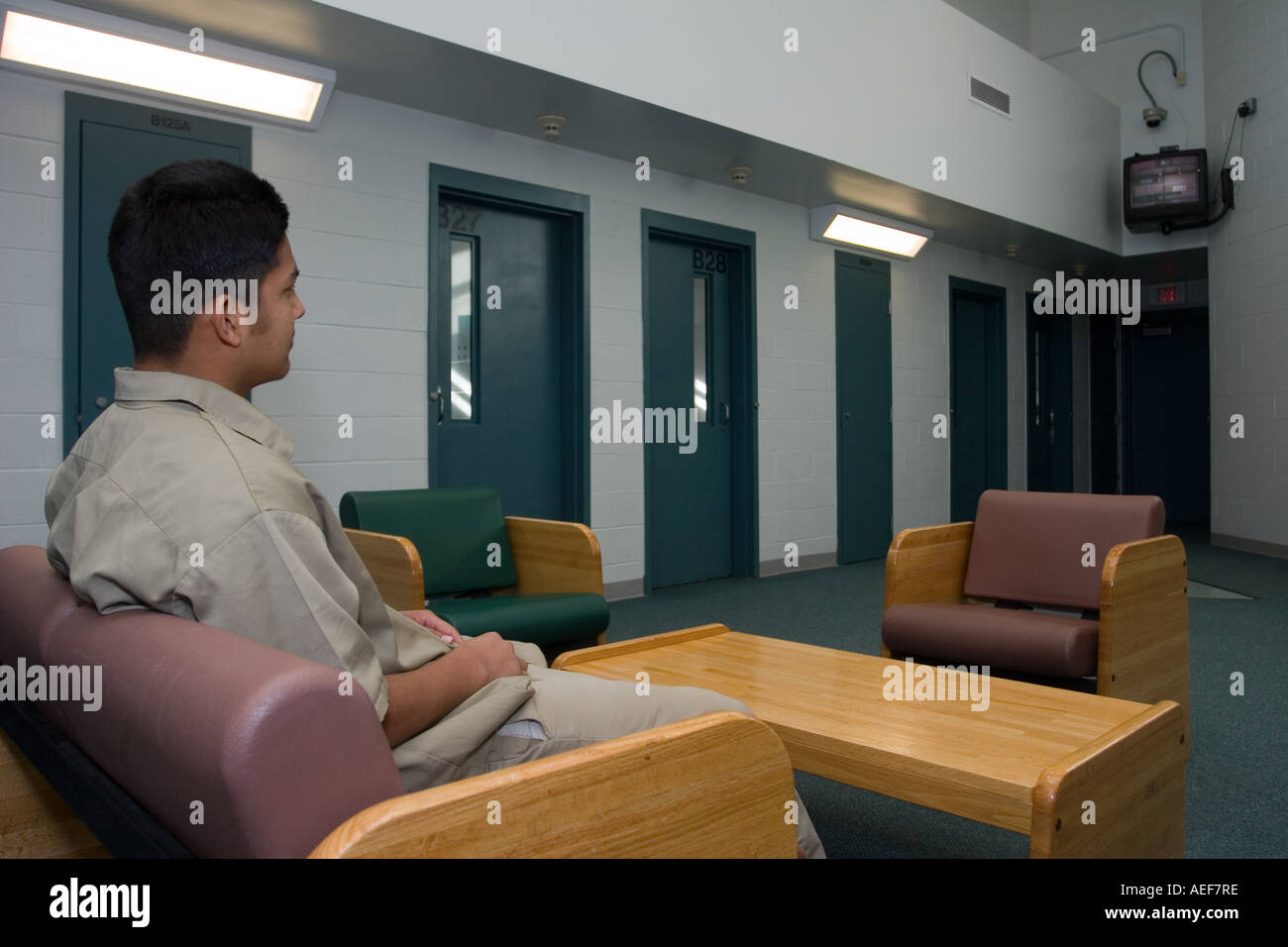 Juvenile inmate watching tv in dayrooml Correctional Youth Facility in Omaha Nebraska, USA. Stock Photo