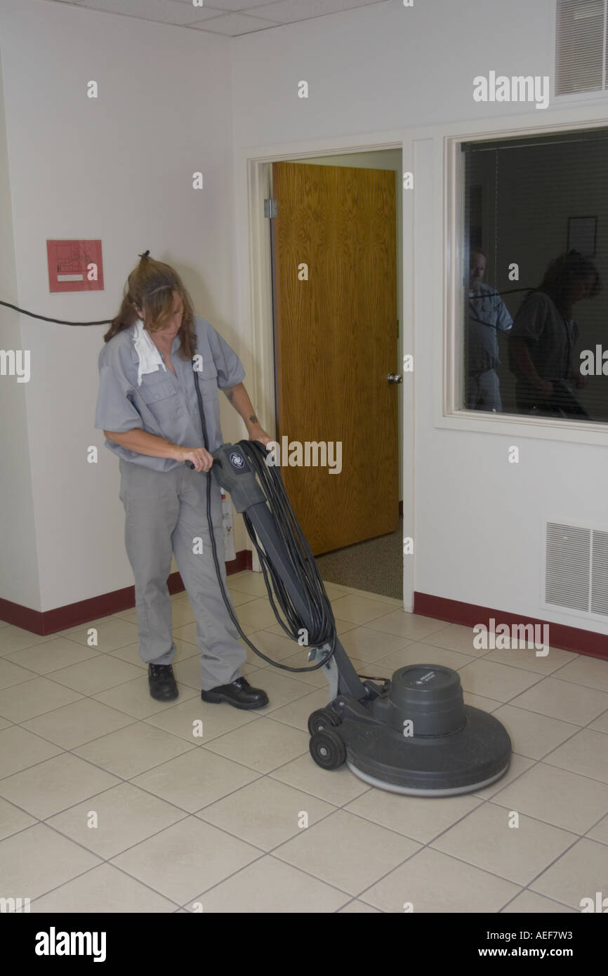 Female inmate waxing the floor in the administrative offices of the Nebraska State Penitentiary Stock Photo