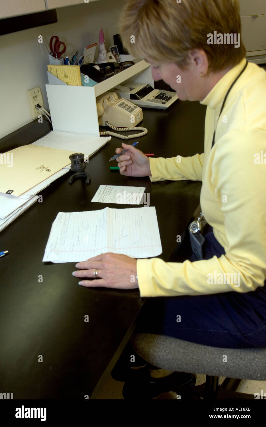 Forensic handwriting expert is comparing two handwriting samples side by side Nebraska State Patrol Crime Lab, USA. Stock Photo