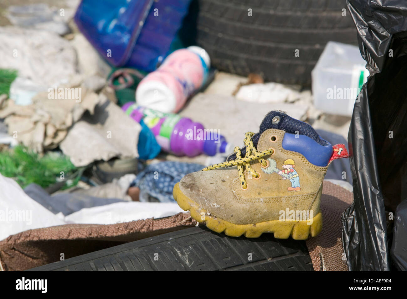 rubbish strewn around a row of derelict abandoned terraced houses in