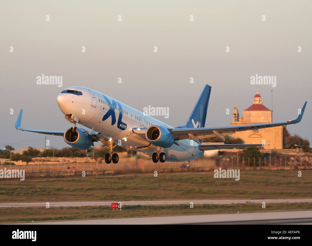 XL Airways Germany Boeing 737-800 passenger jet plane taking off from Malta at sunset Stock Photo